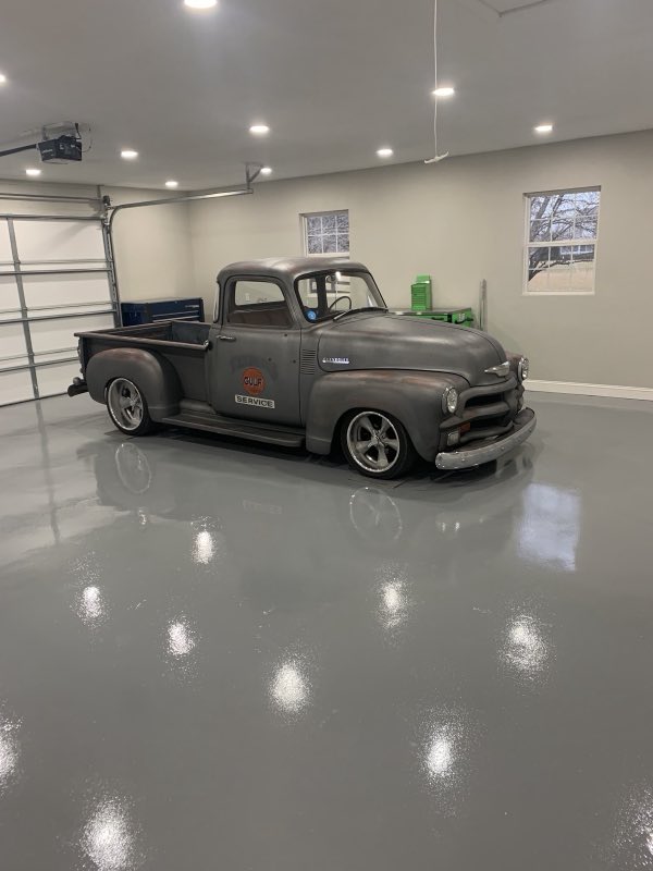 Restored classic Chevrolet pickup on a polished shop floor