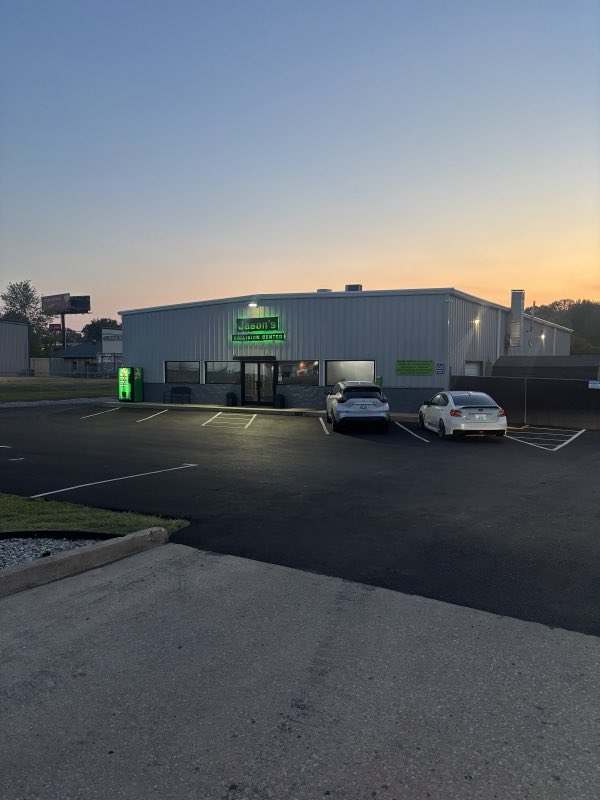 Wide view of the Jason's Collision Center building at dusk