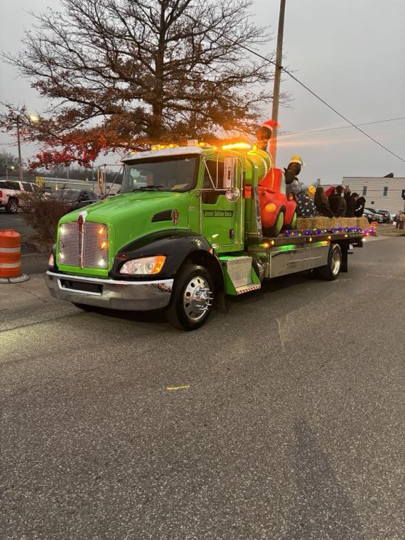 Green Jason's Collision Center flatbed tow truck